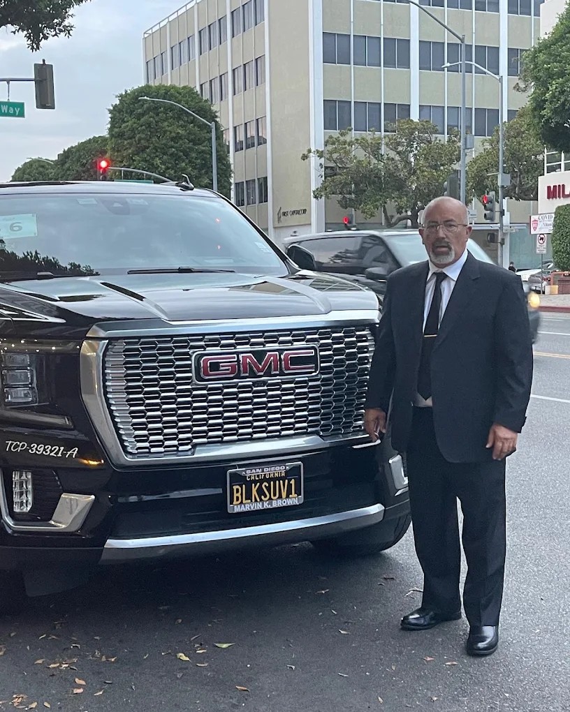My Black SUV chauffeur beside the GMC Yukon Denali